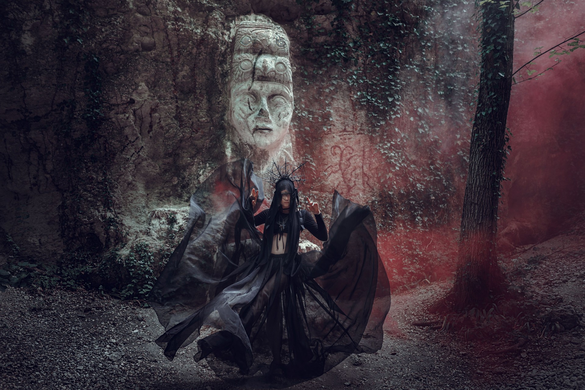 A beautiful woman with pale skin in a black dress and in the black crownk. Gothic look. Outfit for halloween.