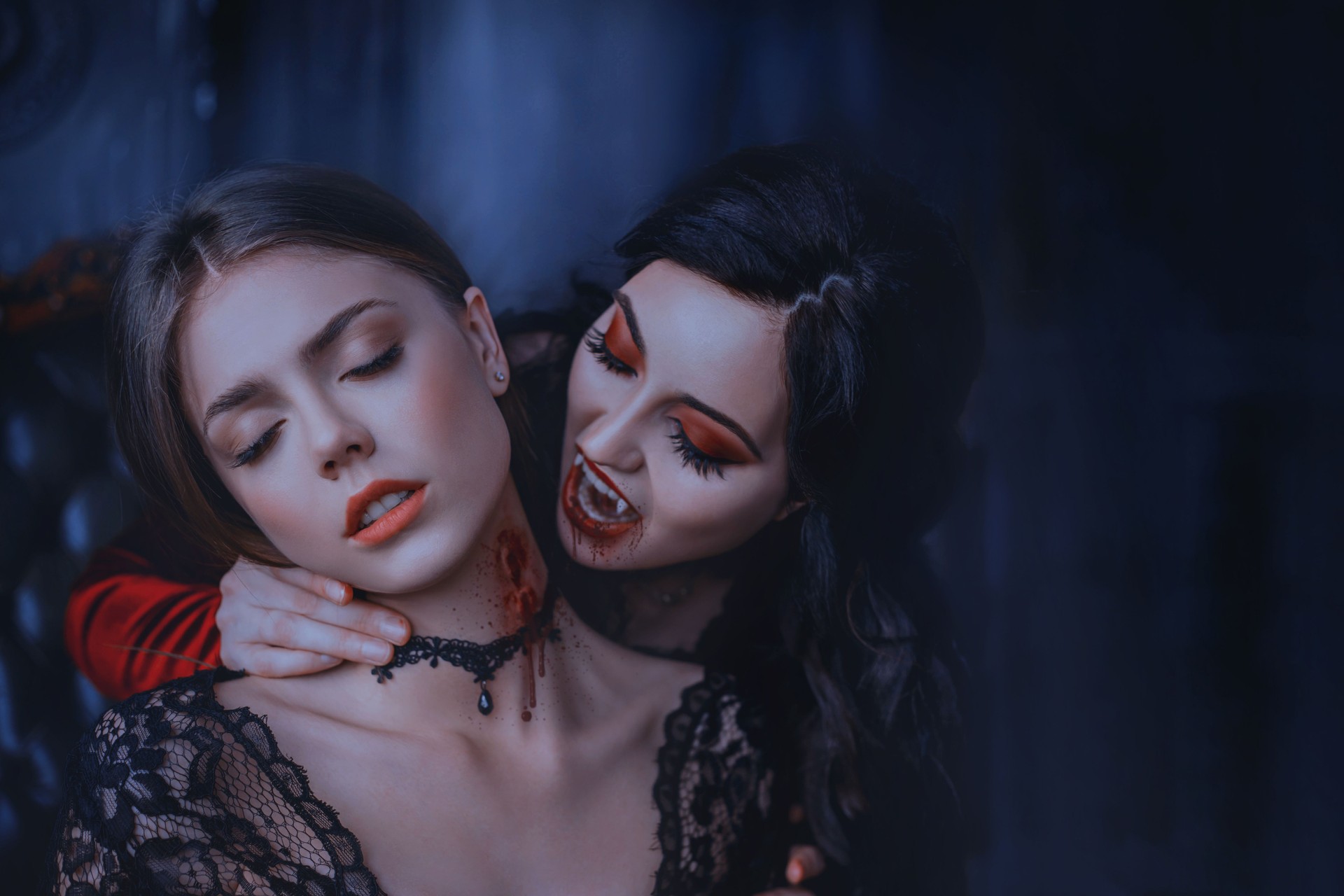 Close Up artwork portrait face sexy vampire woman bites eating drinks young princess. Makeup Drop blood. Bloody wounds bite on neck blonde girl. Horror night halloween. Holiday scary make-up red lips